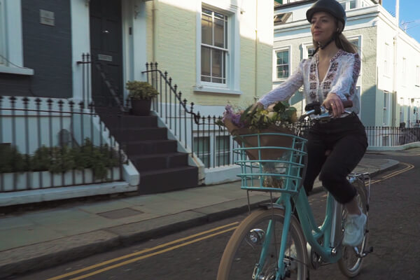 Woman riding Volt Kensington electric bikes in London